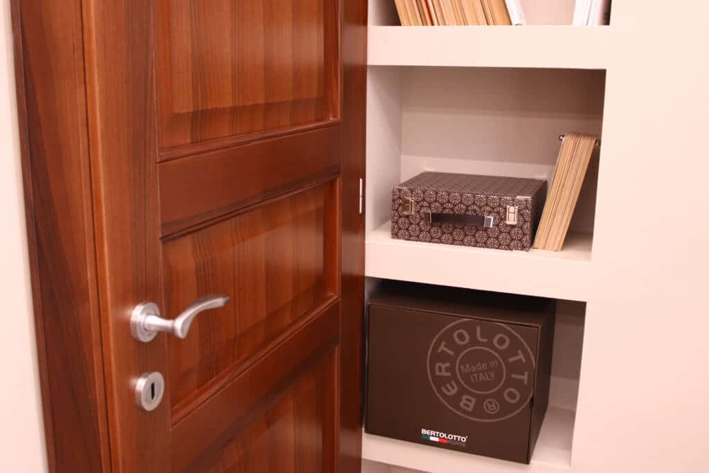 Porta in legno aperta con scaffale e scatole.